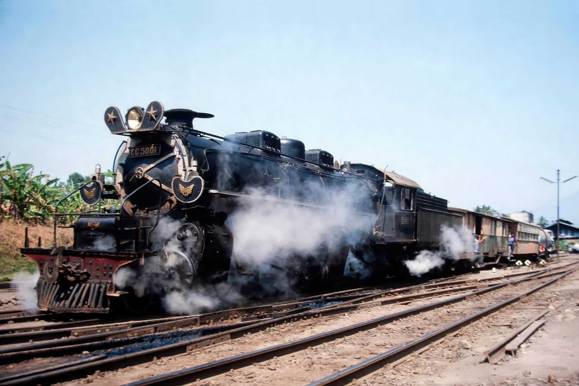 Steam locomotive passing through Javanese countryside